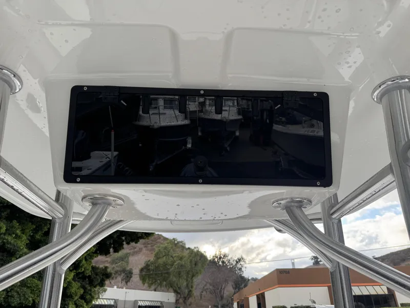Slide: The Image of 2025 Defiance Catalina 240 boat with T-top and electronics box, outdoor setting. - 22