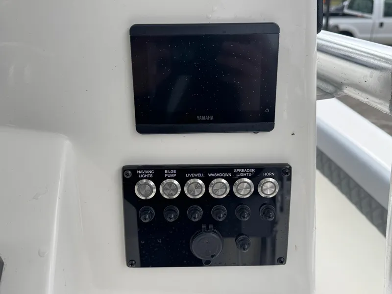 Slide: The Image of Control panel of 2025 Defiance Catalina 240 boat with switches and display. - 29