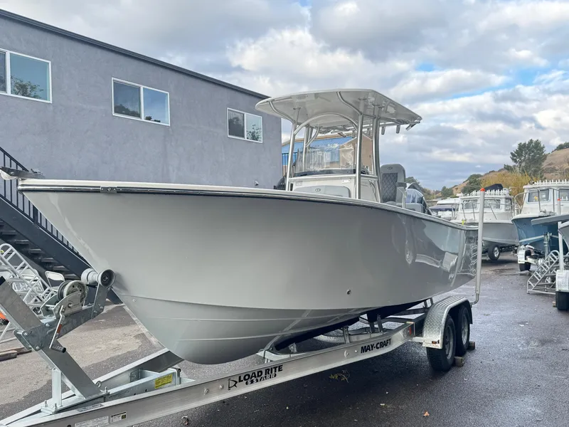 Slide: The Image of 2025 Defiance Catalina 240 boat on trailer, parked outdoors under cloudy sky. - 3