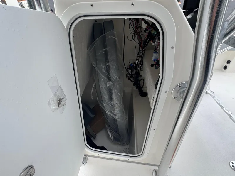 Slide: The Image of 2025 Defiance Catalina 240 storage compartment with wiring and equipment inside. - 31