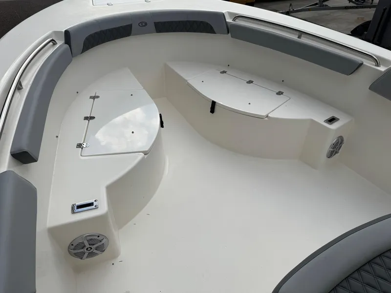 Slide: The Image of 2025 Defiance Catalina 240 boat interior with cushioned seating and storage compartments. - 34