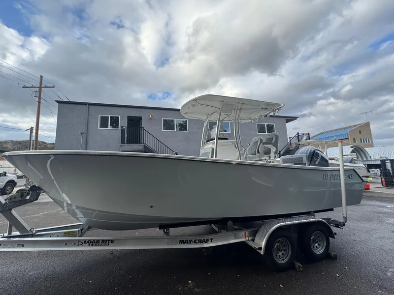 Slide: The Image of 2025 Defiance Catalina 240 boat on trailer, parked outdoors under cloudy sky. - 4