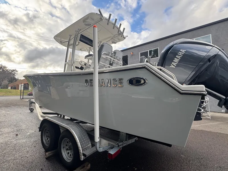 Slide: The Image of 2025 Defiance Catalina 240 boat on trailer, featuring Yamaha outboard motor, parked outdoors. - 5