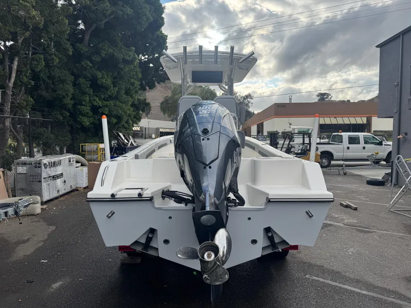 Slide: The Image of 2025 Defiance Catalina 240 boat with outboard motor, parked outdoors. - 6