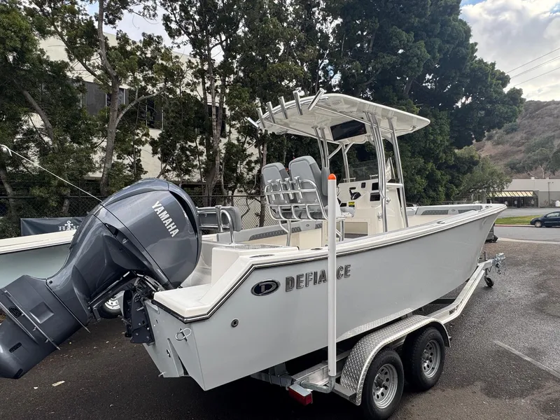 Slide: The Image of 2025 Defiance Catalina 240 boat on trailer with Yamaha outboard motor, parked outdoors. - 7