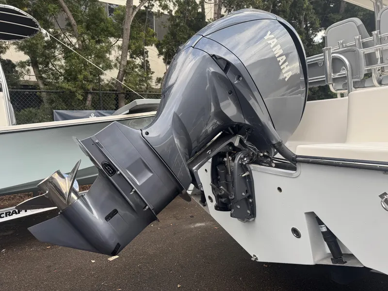 Slide: The Image of 2025 Defiance Catalina 240 boat with Yamaha outboard motor, parked outdoors. - 9