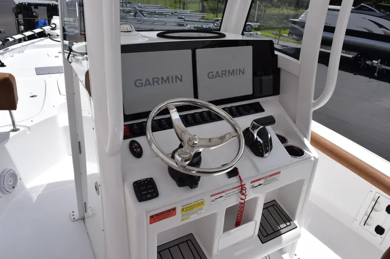 Slide: The Image of 2024 Sea Hunt BX 25 FS boat helm with Garmin displays and steering wheel. - 10