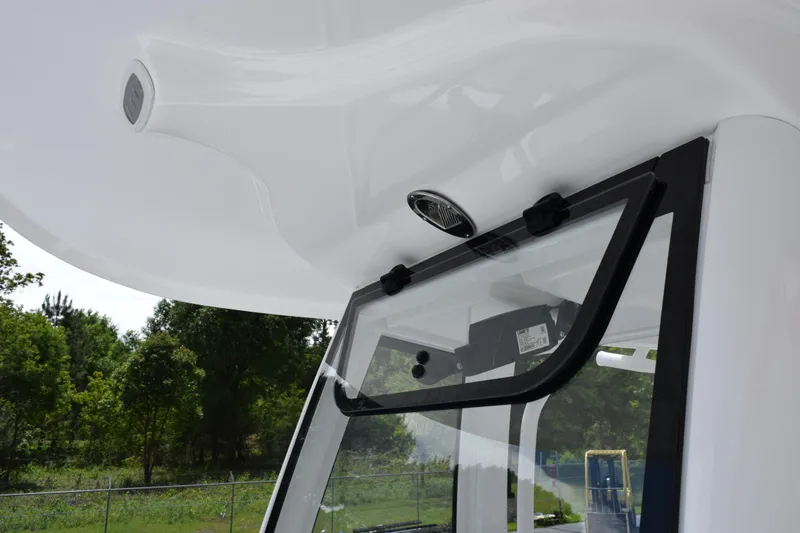 Slide: The Image of 2024 Sea Hunt BX 25 FS boat windshield and roof detail with outdoor background. - 14