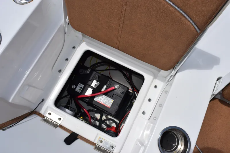Slide: The Image of 2024 Sea Hunt BX 25 FS boat battery compartment with brown seating and wiring. - 15