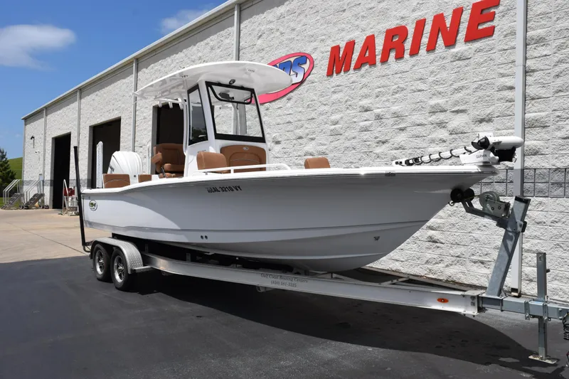 Slide: The Image of 2024 Sea Hunt BX 25 FS boat on trailer outside marine dealership. - 2