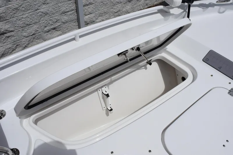 Slide: The Image of 2024 Sea Hunt BX 25 FS boat storage compartment open, showcasing interior space. - 20