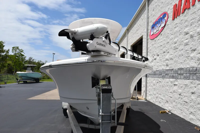 Slide: The Image of 2024 Sea Hunt BX 25 FS boat with Garmin equipment, parked outside a marine shop. - 3