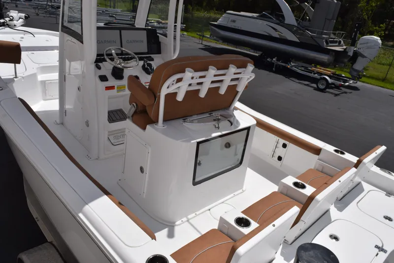 Slide: The Image of 2024 Sea Hunt BX 25 FS boat interior with brown seating and Garmin navigation system. - 7