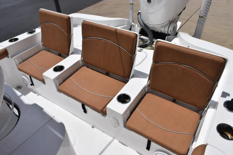 Slide: The Image of 2024 Sea Hunt BX 25 FS boat with three brown cushioned seats and cup holders. - 9