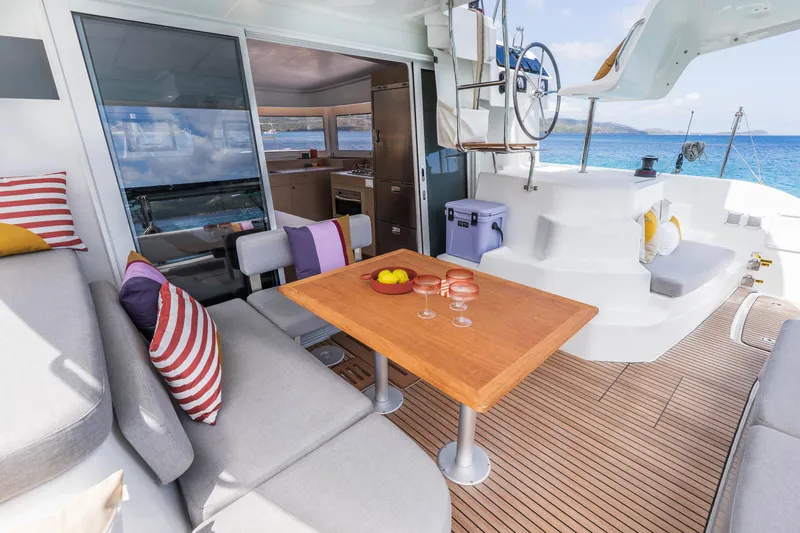 Slide: The Image of Luxurious Lagoon 38 catamaran interior, featuring a stylish dining area with ocean view, 2025 model. - 20