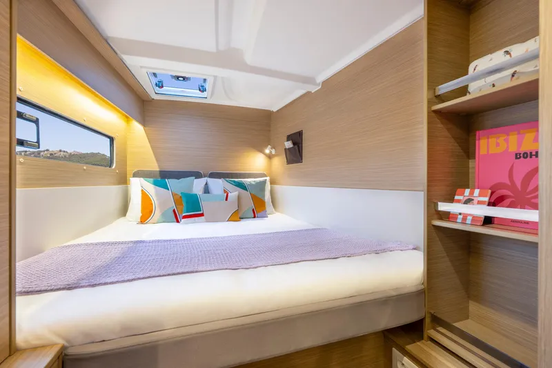 Slide: The Image of Cozy cabin interior of 2025 Lagoon 38 catamaran with modern decor and natural lighting. - 41