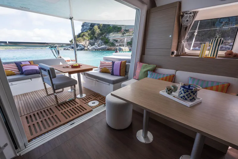 Slide: The Image of Interior of 2025 Lagoon 38 catamaran with cozy seating and ocean view. - 47