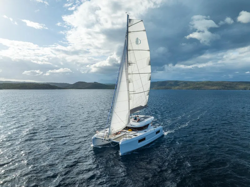 Slide: The Image of Sailing Lagoon 38 catamaran on open sea under cloudy sky, 2025 model. - 63