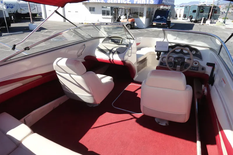 Slide: The Image of Interior of a 2000 Glastron GX 205 boat with red and white seating. - 11