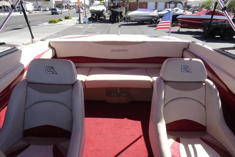 Slide: The Image of Interior of a 2000 Glastron GX 205 boat with red and beige seating. - 13