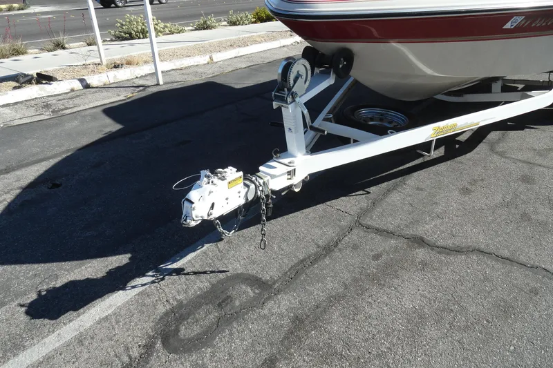 Slide: The Image of Trailer hitch of a 2000 Glastron GX 205 boat on pavement. - 16