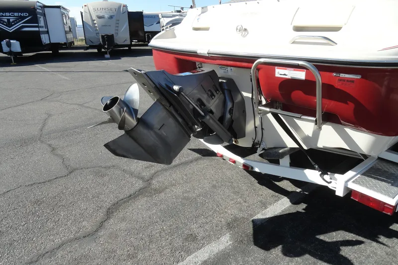 Slide: The Image of 2000 Glastron GX 205 boat stern with outboard motor and propeller in parking lot. - 18
