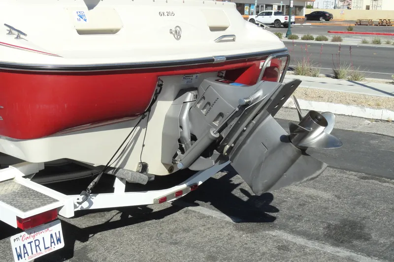 Slide: The Image of Rear view of a 2000 Glastron GX 205 boat with visible propeller and trailer. - 19