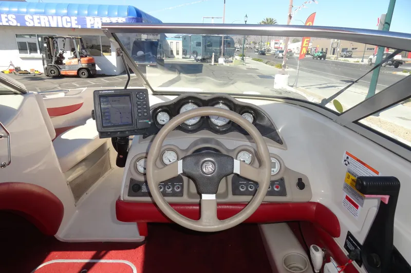 Slide: The Image of Interior view of a 2000 Glastron GX 205 boat dashboard with steering wheel and navigation system. - 8