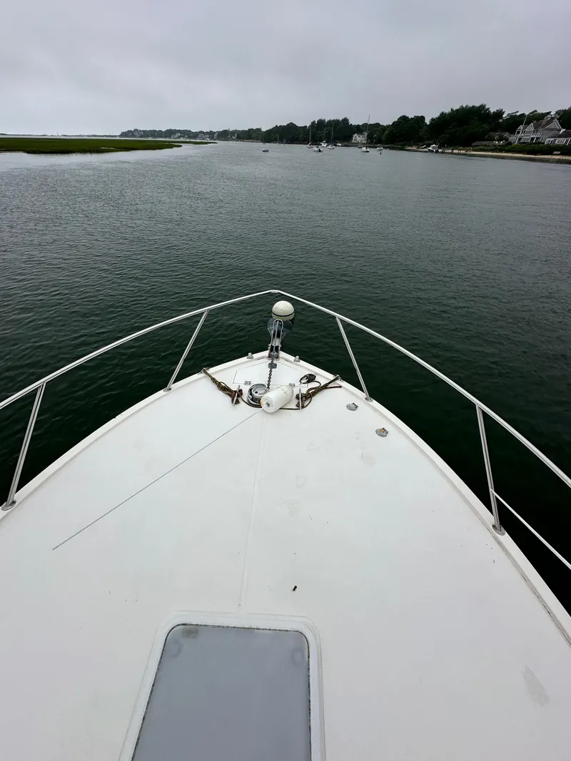 Slide: The Image of Bow of a 2006 Carolina Classic 28FT boat on calm water. - 13