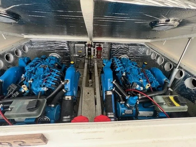 Slide: The Image of Engine compartment of a 2006 Carolina Classic 28FT boat with twin blue engines. - 15