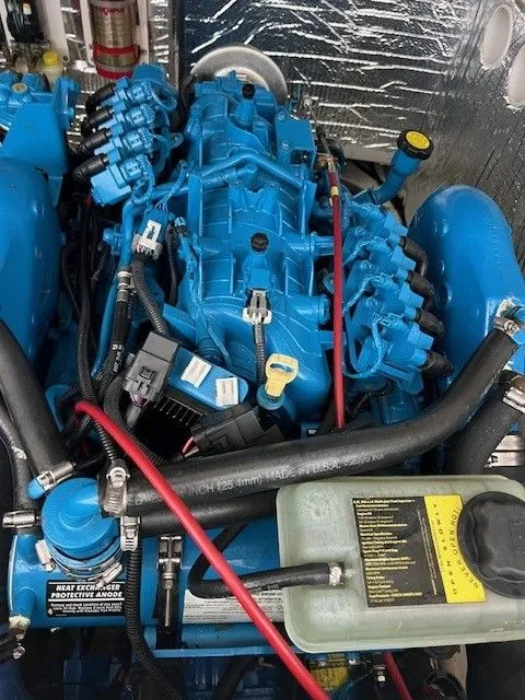 Slide: The Image of Engine of a 2006 Carolina Classic 28FT boat, painted blue. - 18