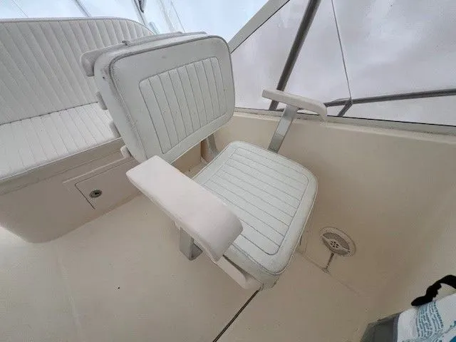 Slide: The Image of Interior of a 2006 Carolina Classic 28FT boat with white seating. - 23