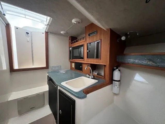 Slide: The Image of Interior of a 2006 Carolina Classic 28FT yacht kitchen. - 26