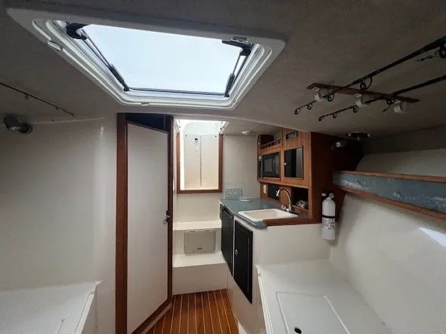Slide: The Image of Interior of a 2006 Carolina Classic 28FT yacht with kitchenette. - 28