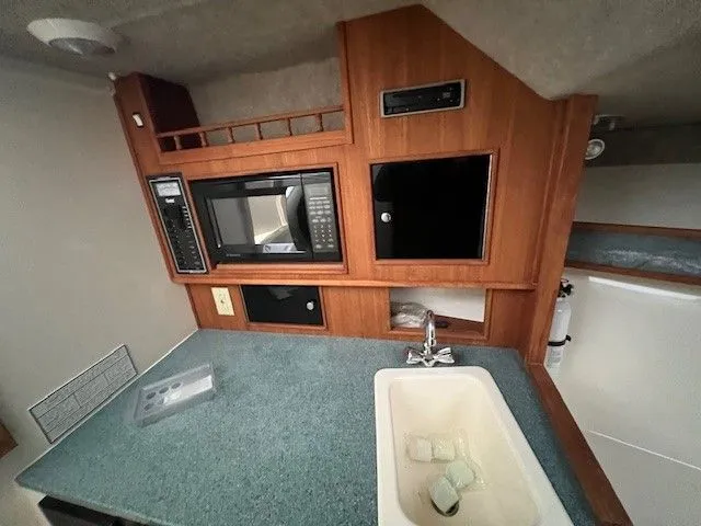 Slide: The Image of Interior of 2006 Carolina Classic 28FT with kitchenette and sink. - 34