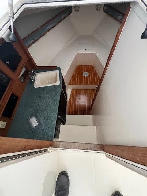 Slide: The Image of Interior of a 2006 Carolina Classic 28FT yacht with kitchenette and wooden flooring. - 36