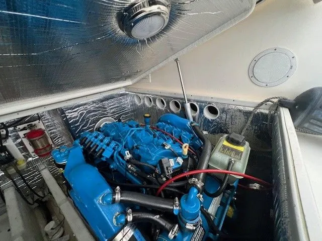 Slide: The Image of Engine compartment of a 2006 Carolina Classic 28FT boat with blue engine. - 42