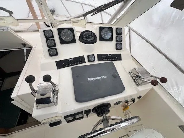 Slide: The Image of Helm console of a 2006 Carolina Classic 28FT boat with Raymarine equipment. - 43