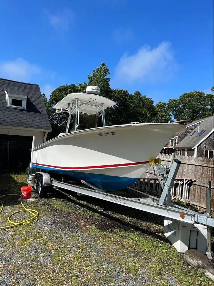 The Image of 1996 Silverhawk 24cc boat on trailer outdoors. - 1