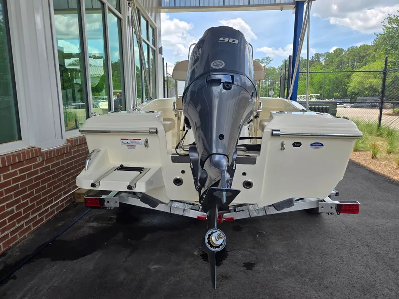 Slide: The Image of 2024 Scout 175 Sportfish boat with outboard motor, parked on trailer. - 9