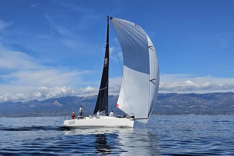 The Image of 2004 J Boats J/109 sailing on calm waters with mountains in the background. - 0