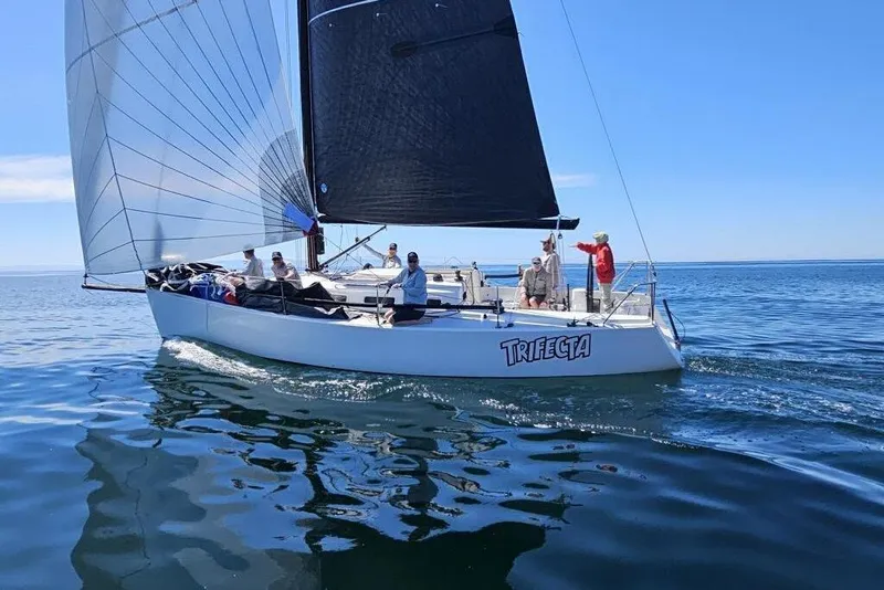 Slide: The Image of 2004 J Boats J/109 sailboat "Trifecta" sailing on calm blue waters. - 12