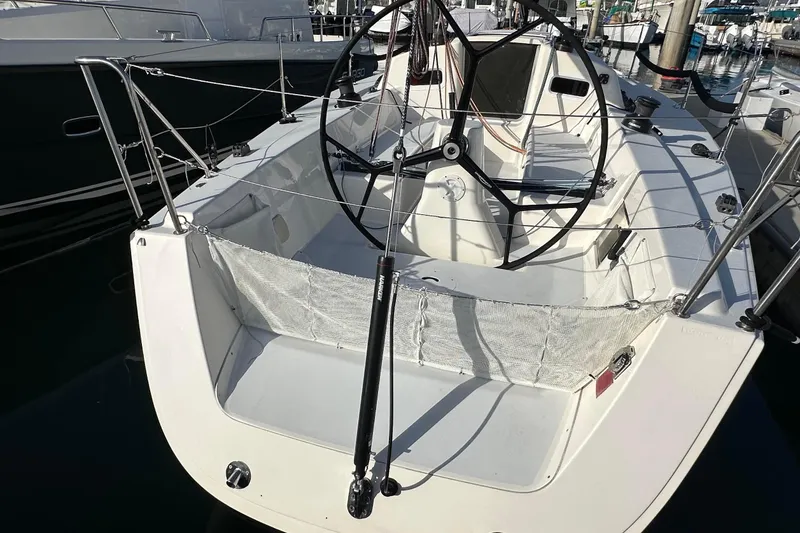 Slide: The Image of 2004 J Boats J/109 sailboat cockpit with steering wheel, docked at marina. - 15