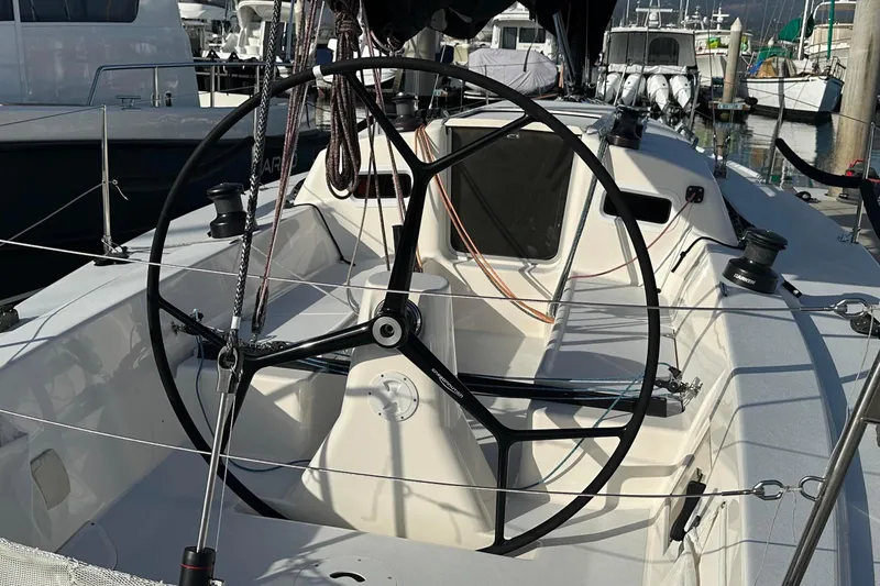 Slide: The Image of 2004 J Boats J/109 sailboat cockpit with steering wheel and rigging details. - 16