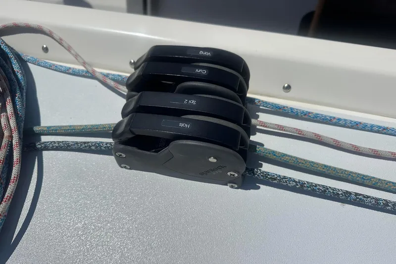 Slide: The Image of Deck rigging on a 2004 J Boats J/109 sailboat, featuring ropes and pulleys. - 23