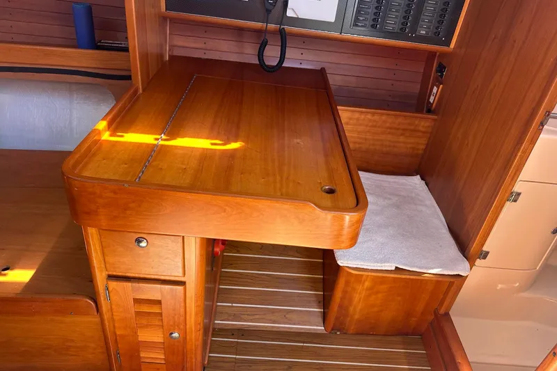 Slide: The Image of 2004 J Boats J/109 yacht interior with wooden cabinetry, stove, and sink. - 34