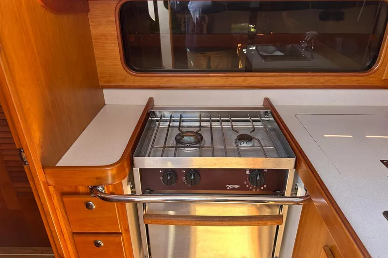Slide: The Image of Galley with propane stove and wooden cabinetry. - 41