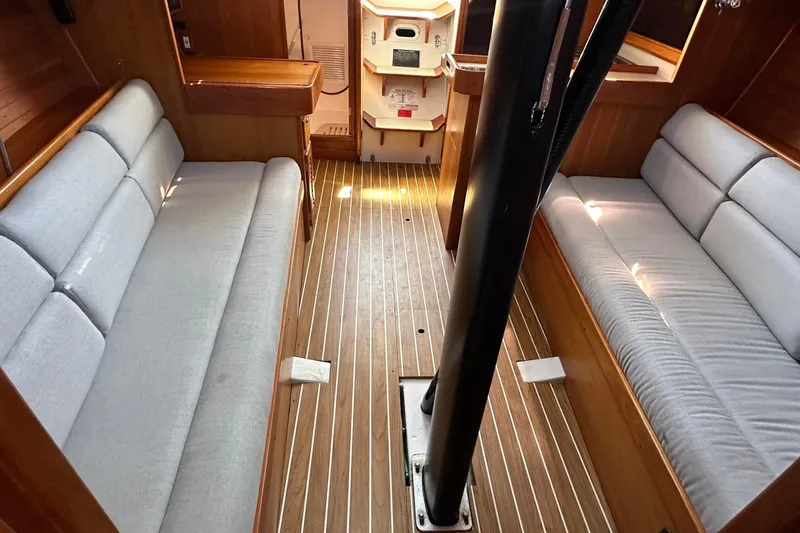 Slide: The Image of Interior of a 2004 J Boats J/109 sailboat with wooden flooring and cushioned seating. - 42