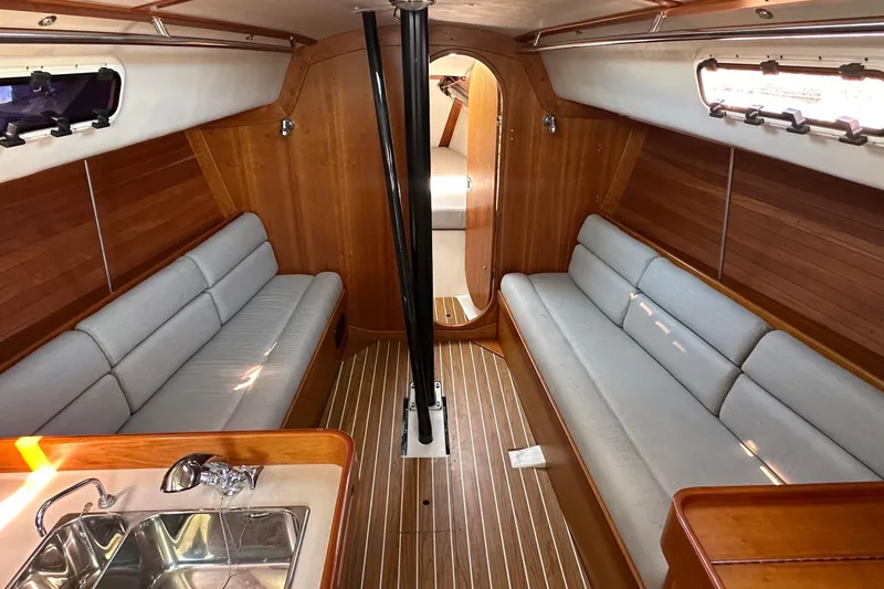 Slide: The Image of Interior of 2004 J Boats J/109 sailboat with wooden finish and cushioned seating. - 43