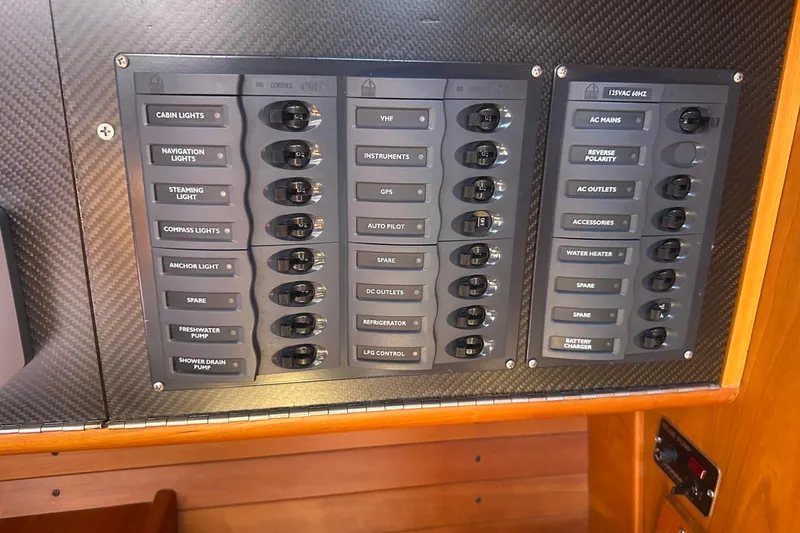 Slide: The Image of Electrical control panel on a 2004 J Boats J/109 sailboat, featuring labeled switches. - 50